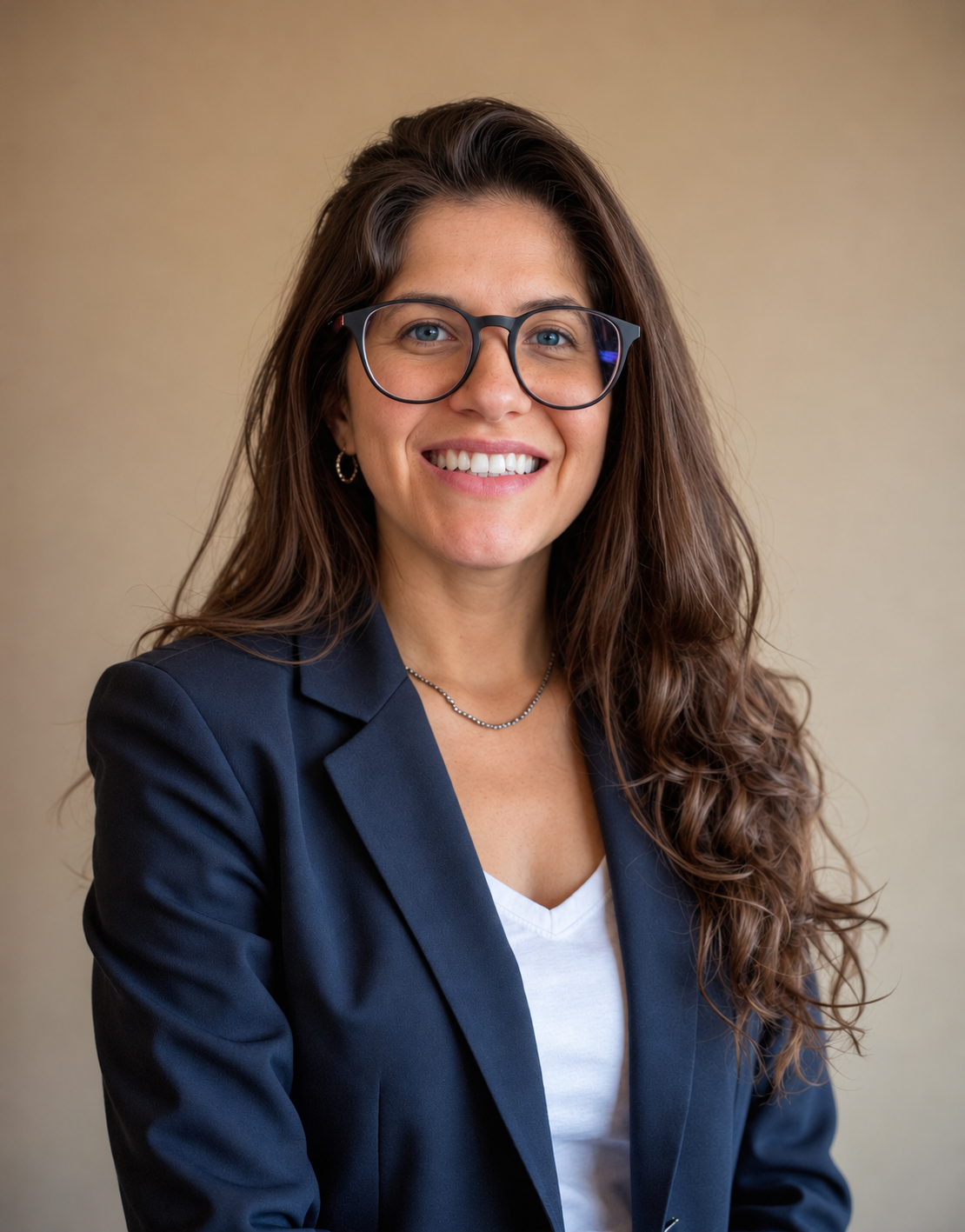 Allison Canton smiling in a blue blazer, white tee, and glasses